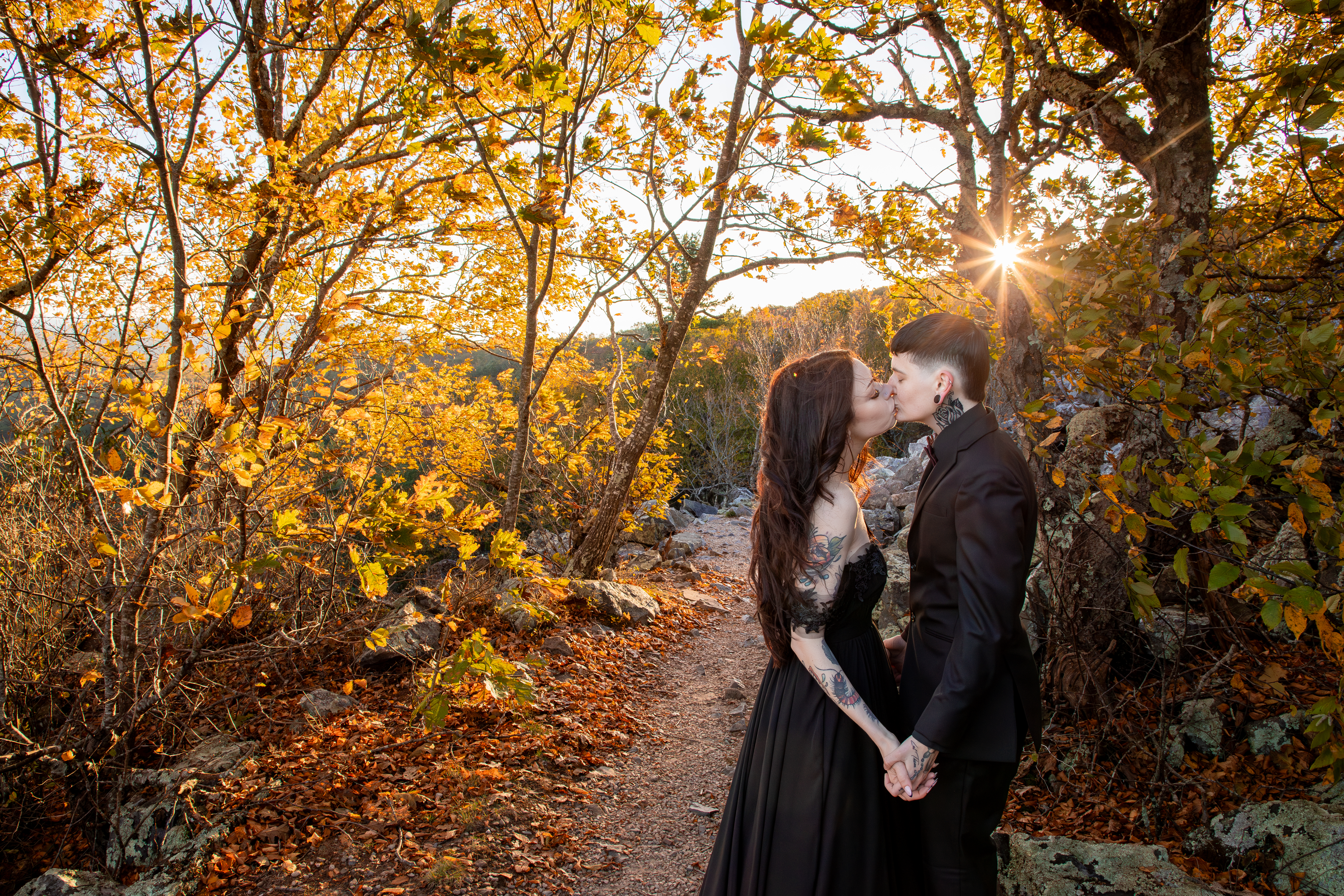Couple kissing on the Blackrock Summit trail surrounded by golden fall foliage