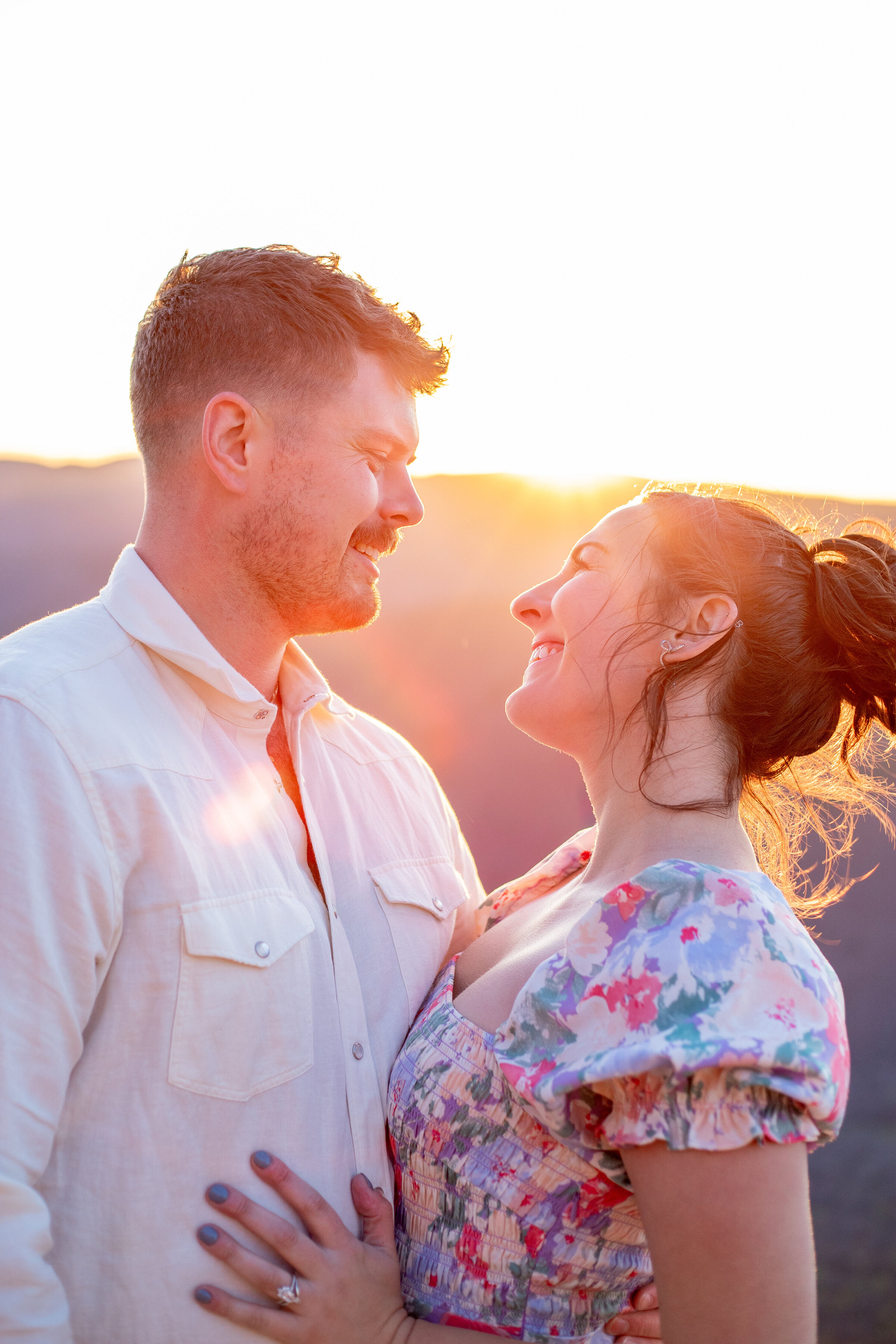 Couple smiling together at golden hour in the Virginia mountains